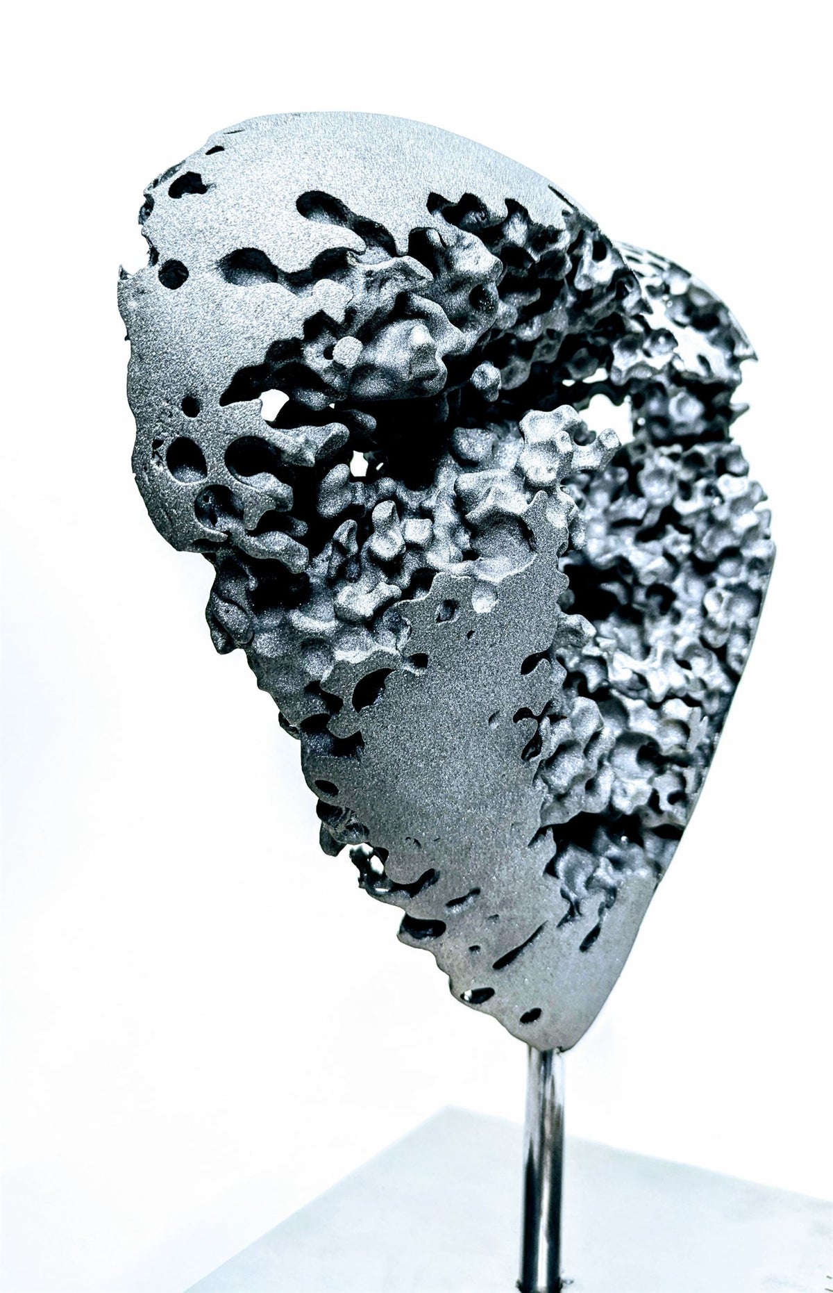 Amour de Tiguéné — sculpture en aluminium brut représentant un cœur marqué d’éclats